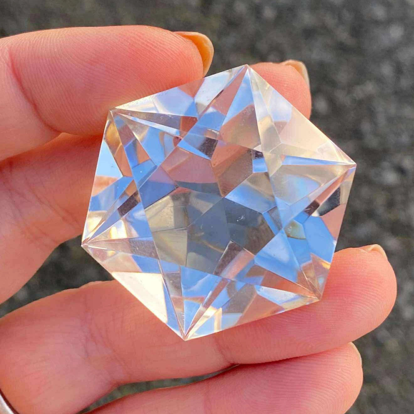 200 carat flawless brazilian clear quartz faceted star cut gemstone, highlighting its complex structure - clearquartzshop