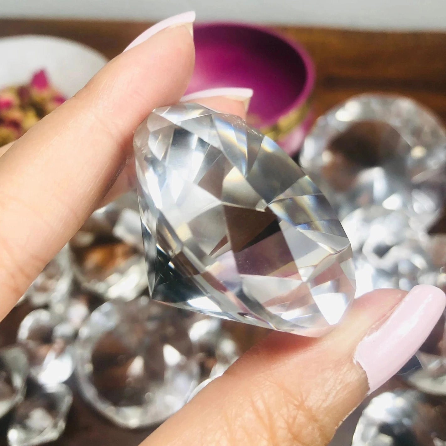 350 carat flawless brazilian clear quartz faceted gemstone held in hand, showcasing its brilliant sparkle - clearquartzshop