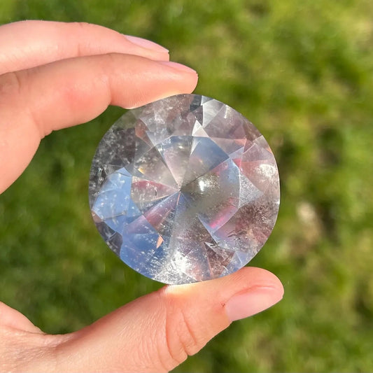 325 carat brazilian clear quartz brilliant faceted gemstone held in hand, showcasing its natural sparkle - clearquartzshop