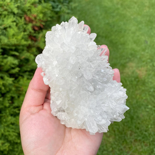 brazilian clear quartz cluster 475g displayed in hand outdoors - healing crystal from clearquartzshop