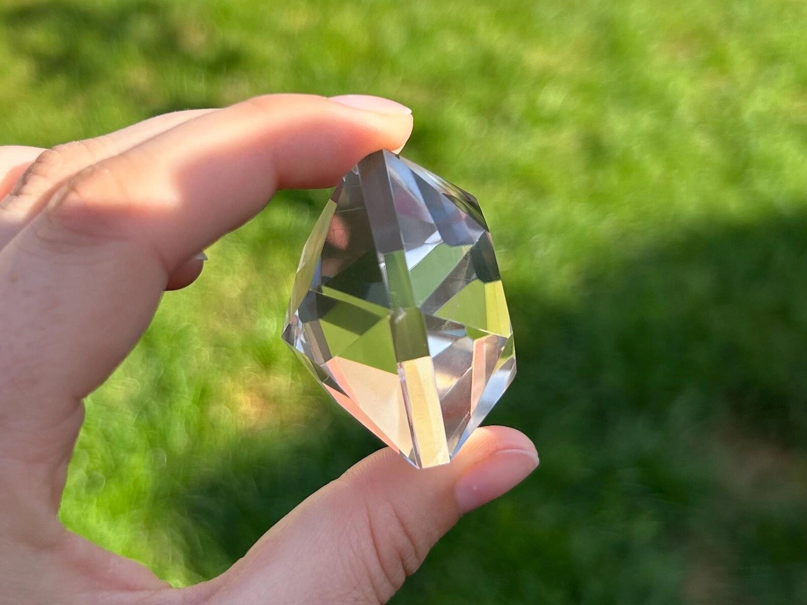 375 carat flawless brazilian clear quartz multi-faceted gemstone, highlighting its intricate cut - clearquartzshop