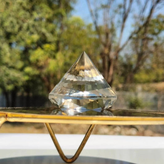 625ct flawless brazilian faceted clear quartz brilliant cut gemstone displayed outdoors on stand - clearquartzshop