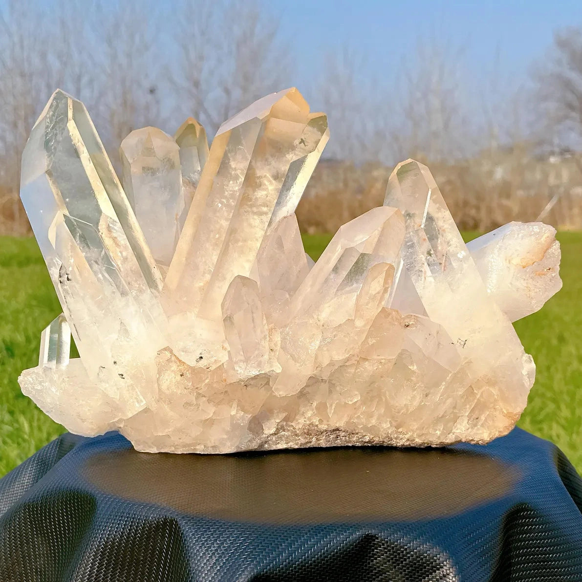 side angle of large brazilian quartz crystal cluster outdoors - clearquartzshop