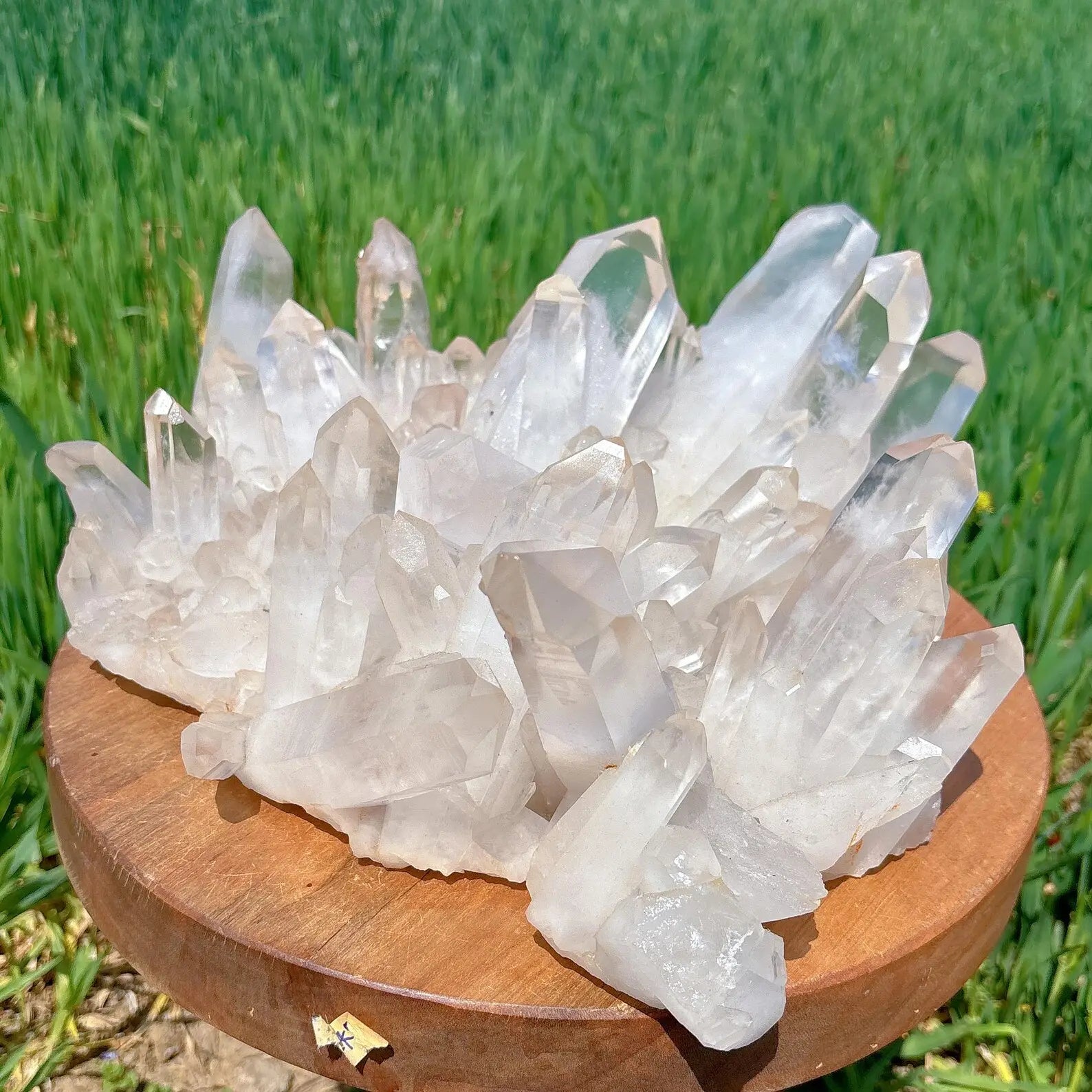premium clear quartz cluster formation on wooden display, outdoor setting - clearquartzshop