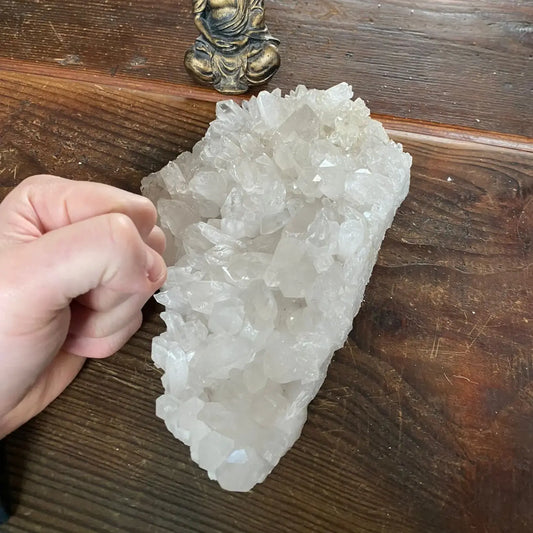 raw brazilian clear quartz cluster weighing 1845g, shown next to a hand - healing crystal from clearquartzshop